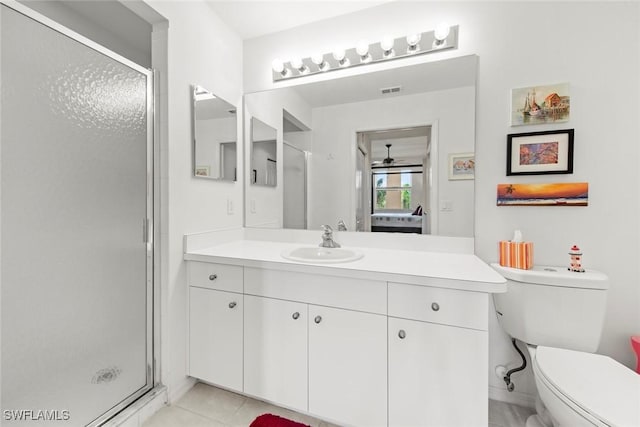 bathroom with tile patterned floors, vanity, toilet, and an enclosed shower