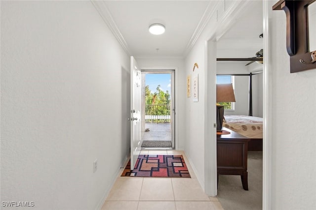 doorway featuring crown molding, light tile patterned floors, and ceiling fan