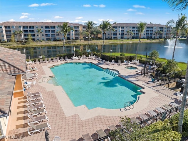 view of swimming pool featuring a patio and a water view