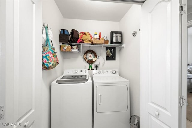 clothes washing area featuring independent washer and dryer