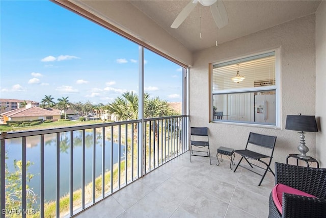 sunroom featuring a water view