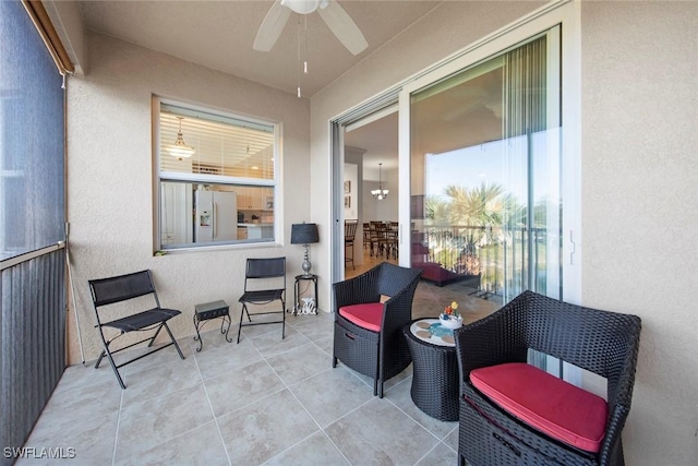 sunroom / solarium featuring a wealth of natural light and ceiling fan