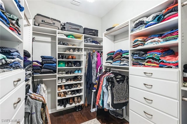 spacious closet with dark hardwood / wood-style floors