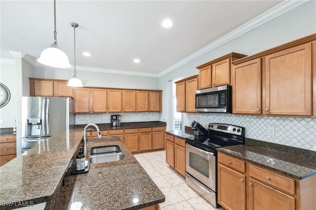 kitchen featuring appliances with stainless steel finishes, decorative light fixtures, tasteful backsplash, a kitchen island with sink, and crown molding