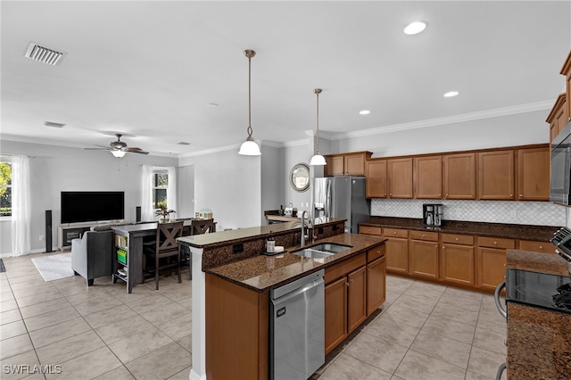 kitchen featuring sink, decorative light fixtures, ornamental molding, and stainless steel appliances