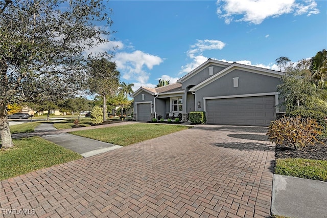 view of front of house featuring a garage and a front lawn