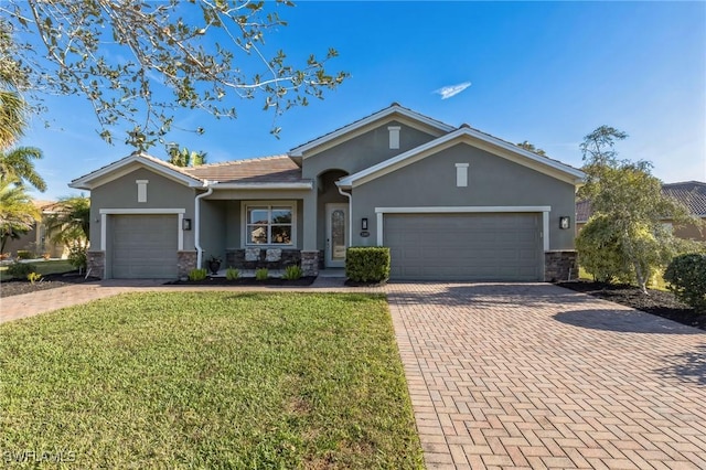 ranch-style home with a garage and a front lawn