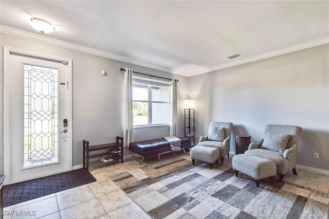 foyer with ornamental molding and light tile patterned floors