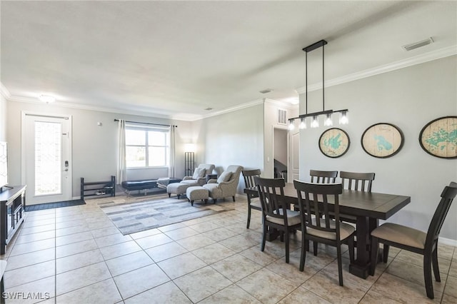 dining space with ornamental molding and light tile patterned floors