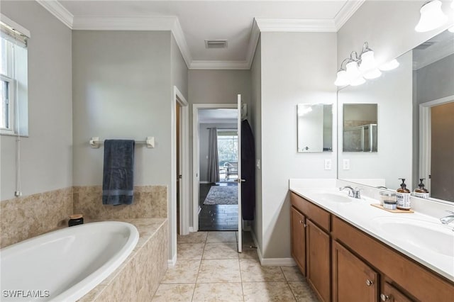 bathroom featuring vanity, tile patterned floors, plenty of natural light, and ornamental molding