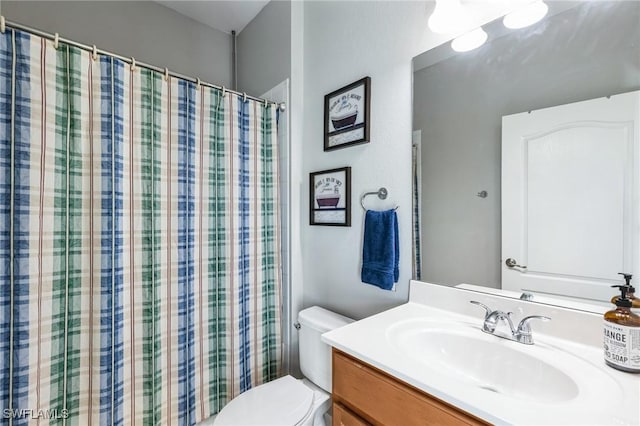 bathroom featuring vanity and toilet