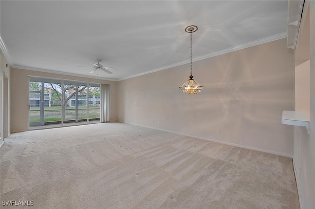 carpeted spare room featuring crown molding and ceiling fan