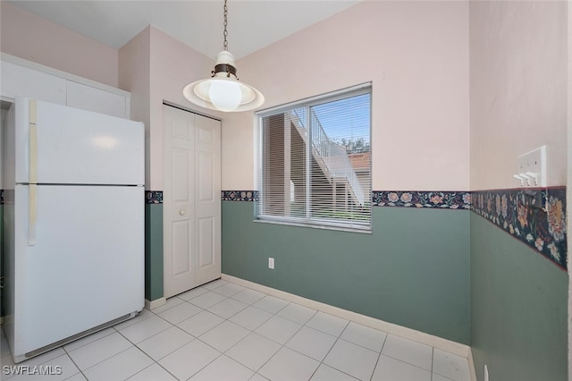 kitchen featuring white refrigerator and light tile patterned floors