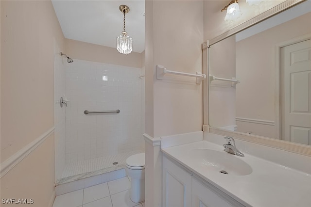 bathroom featuring tiled shower, tile patterned floors, toilet, and vanity