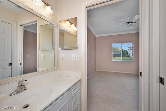 bathroom with crown molding, vanity, and ceiling fan