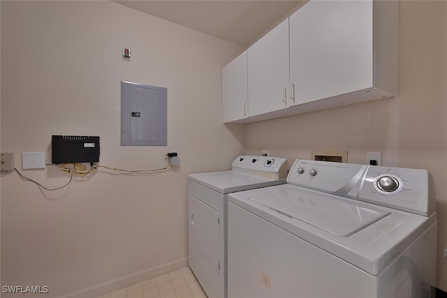 laundry room with electric panel, cabinets, and washing machine and clothes dryer