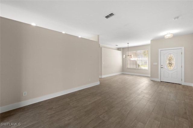 interior space featuring a notable chandelier and dark hardwood / wood-style floors