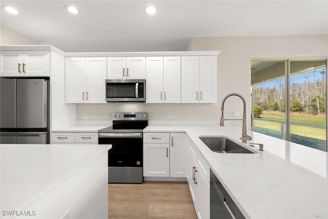 kitchen featuring stainless steel appliances, sink, and white cabinets