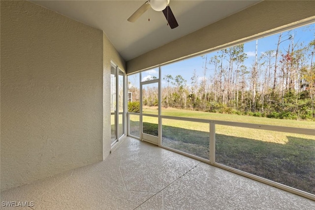 unfurnished sunroom with ceiling fan