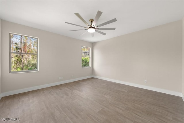 unfurnished room with hardwood / wood-style floors and ceiling fan