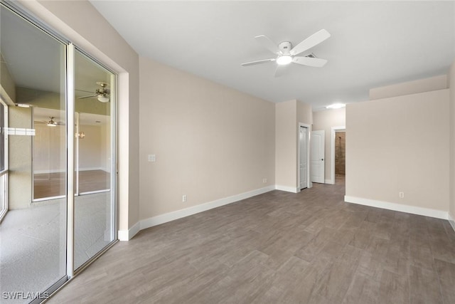 unfurnished room with hardwood / wood-style floors and ceiling fan