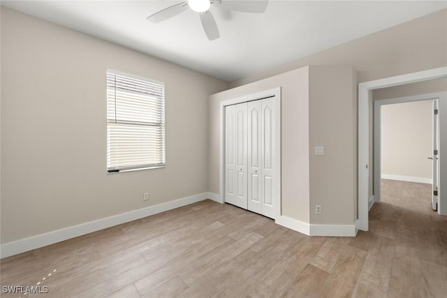 unfurnished bedroom featuring light hardwood / wood-style flooring, ceiling fan, and a closet