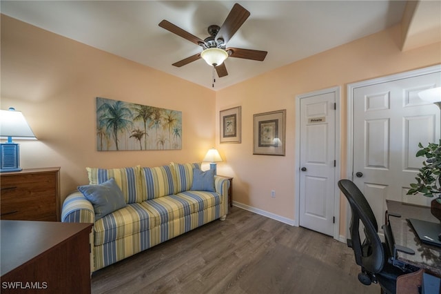 home office featuring dark hardwood / wood-style floors and ceiling fan