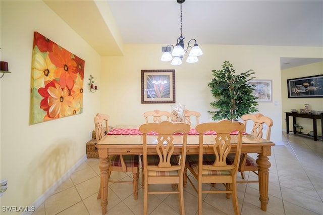 tiled dining area featuring a chandelier