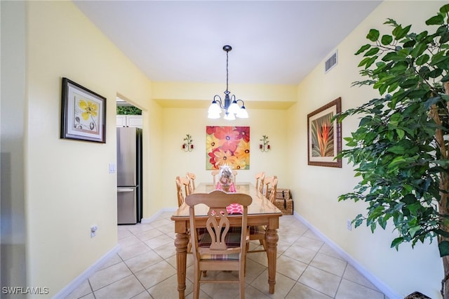 dining space featuring light tile patterned floors and an inviting chandelier