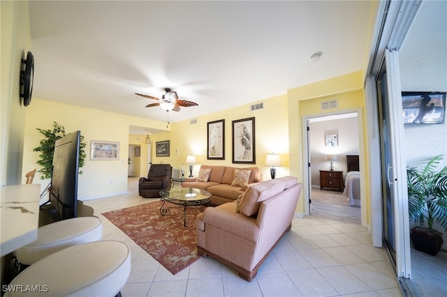 living room with ceiling fan and light tile patterned flooring