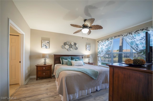 bedroom with ceiling fan and light wood-type flooring