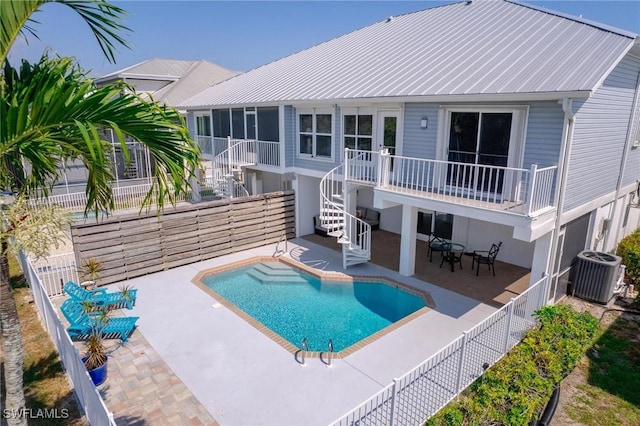 view of pool featuring a patio and central air condition unit