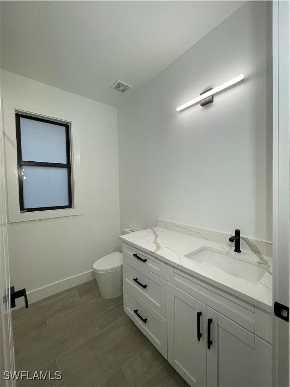 bathroom with vanity and toilet