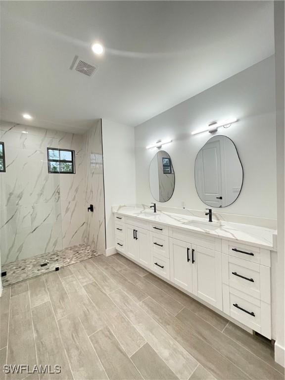 bathroom featuring vanity and a tile shower