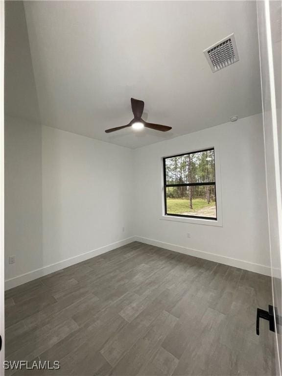 empty room with dark hardwood / wood-style floors and ceiling fan