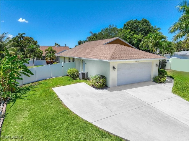 ranch-style house with a front yard, central AC unit, fence, stucco siding, and a garage