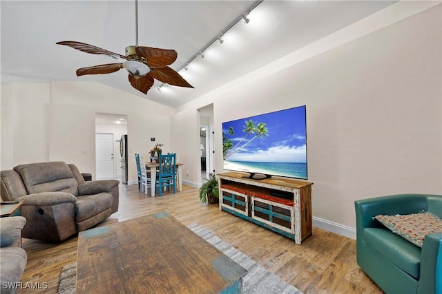 living area with a ceiling fan, wood finished floors, baseboards, lofted ceiling, and track lighting