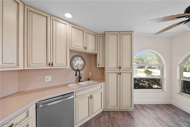 kitchen featuring a sink, cream cabinets, light wood-style floors, light countertops, and dishwasher