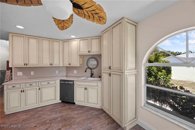 kitchen with a sink, cream cabinetry, and light countertops