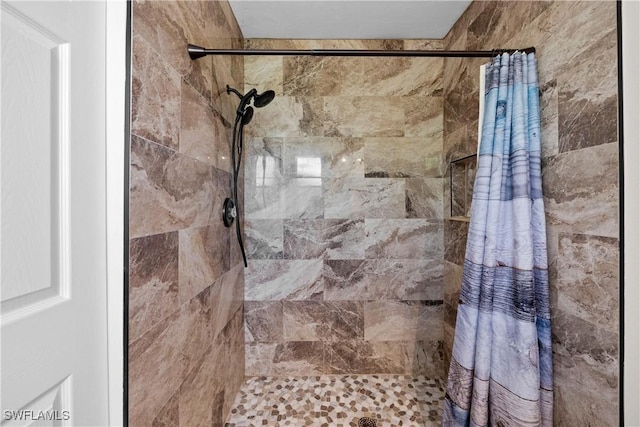 bathroom with tiled shower