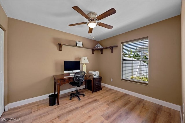 home office with light wood-type flooring, baseboards, and ceiling fan