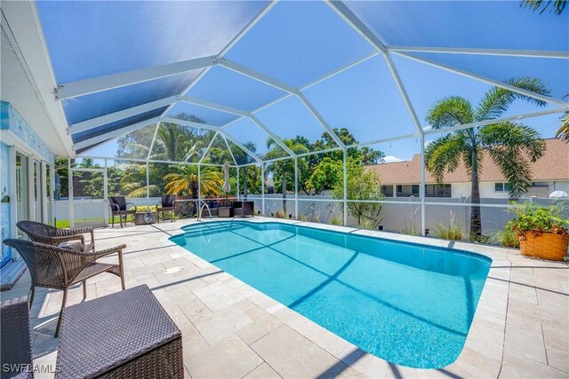 view of pool featuring a patio and glass enclosure