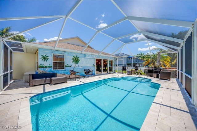 outdoor pool featuring an outdoor living space, glass enclosure, and a patio