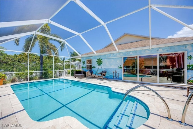 outdoor pool with glass enclosure and a patio area