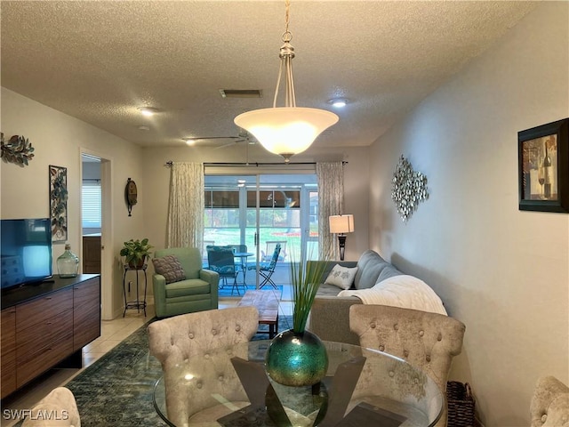 living room featuring a textured ceiling and light tile patterned flooring