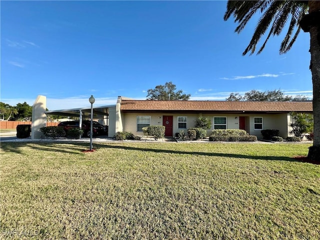 ranch-style house featuring a carport and a front lawn