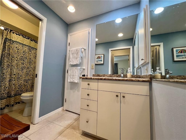 bathroom with vanity, tile patterned floors, and toilet