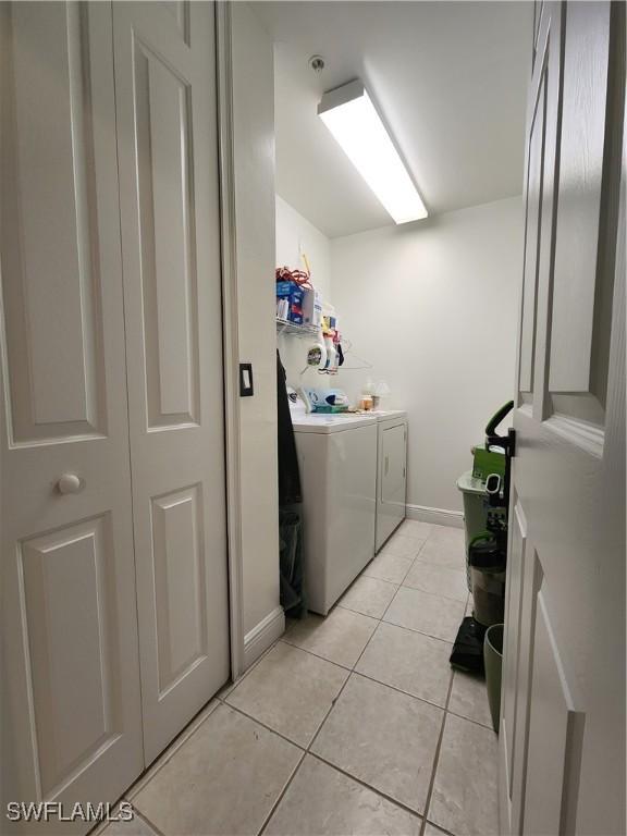 washroom with washer and dryer and light tile patterned floors