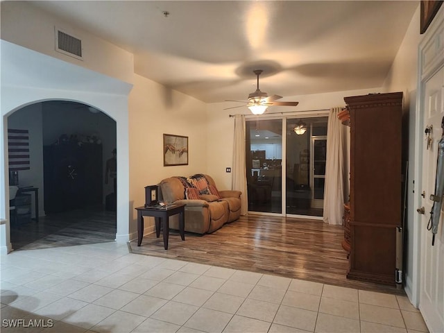 living room with light tile patterned floors and ceiling fan