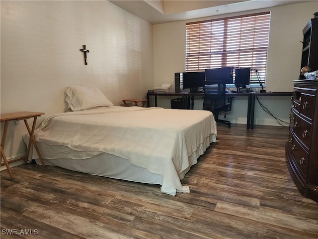 bedroom featuring dark hardwood / wood-style flooring